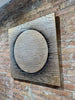 Aura-brick-wall-mixed-media-wood-art-artist-Cie-Hoover-Decorative wall art with circular design on a brick wall