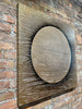 Aura-brick-wall--mixed-media-wood-art-artist-Cie-Hoover-Decorative wall art with circular design on a brick wall