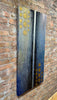 Centered-brick-wall-mixed-media-wood-art-artist-Cie-Hoover-Abstract art piece with blue and gold patterns on a brick wall