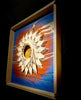 Colorado-Snow-mixed-media-wood-art-artist-Cie-Hoover-Decorative wall art with a sun-like design on a blue background, framed in wood
