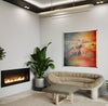 From-Above--living-room-fireplace-mixed-media-wood-art-artist-Cie-Hoover-Modern living room with a fireplace, sofa, and abstract painting of mountains