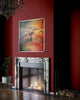 From-Above-conservative-living-room-fireplace-mixed-media-wood-art-artist-Cie-Hoover-Fireplace with a marble mantle against a red wall, featuring a colorful abstract painting of mountains above it.