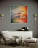 From-Above-modern--living-room-mixed-media-wood-art-artist-Cie-Hoover-Modern living room with a colorful abstract painting of mountains on a gray wall, a white cabinet, and a chair.