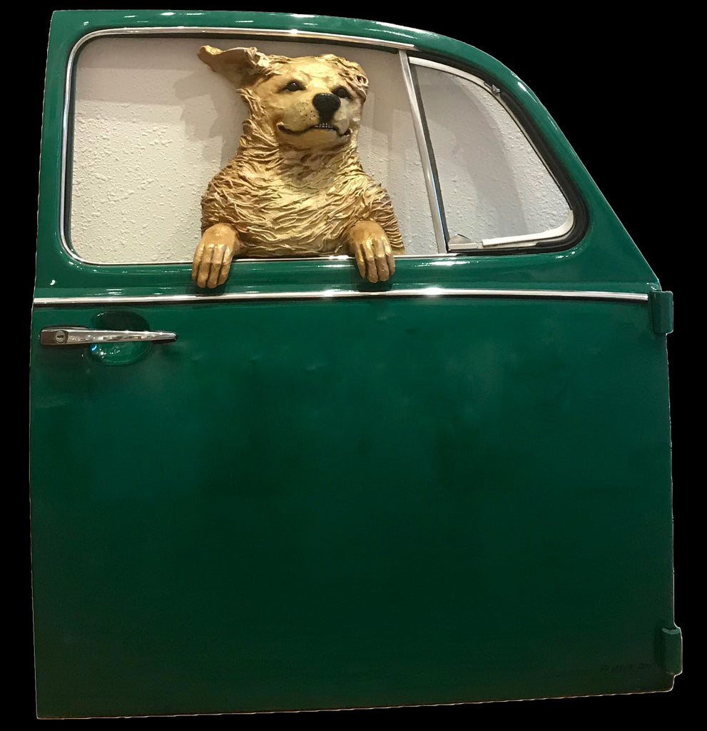 Golden dog in a green Volkswagen door 