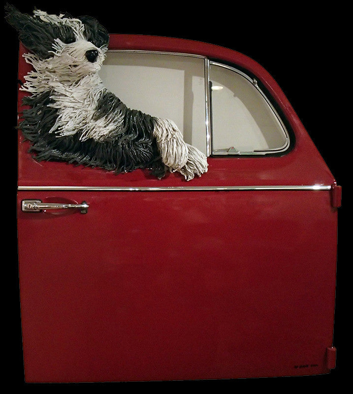 Lounging Sheepdog in a Red VW Door